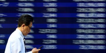 Stocks, dollar slide as Trump's attacks on Fed shake markets