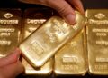 Gold slips 2% as oil rally brings Fed rate hikes into focus