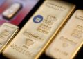 Gold holds near two-week high on easing Fed rate-hike bets